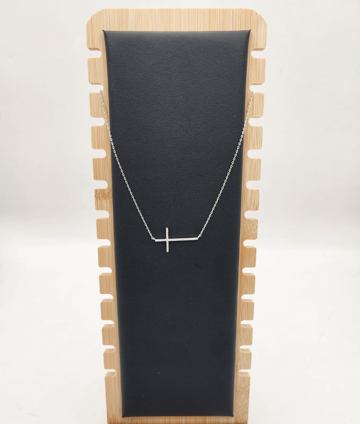 Sideways gold cross necklace